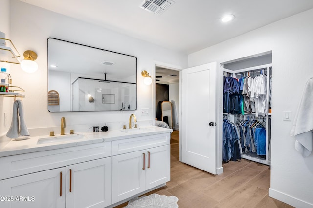 9005 W Villa Chula St, Peoria, AZ 85383 - bathroom featuring a stall shower, wood finished floors, double vanity, and a spacious closet