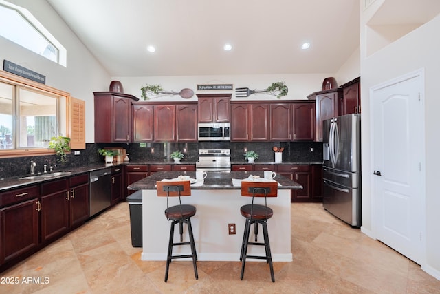 3597 W Mineral Butte Dr, San Tan Valley, AZ 85144 - kitchen with stainless steel appliances, a center island, a breakfast bar, backsplash, and lofted ceiling
