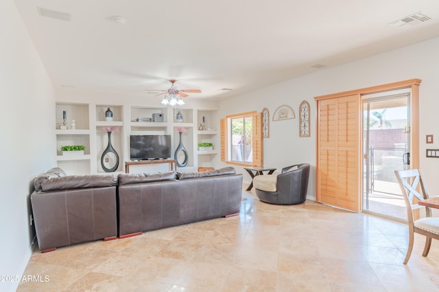 3597 W Mineral Butte Dr, San Tan Valley, AZ 85144 - living room with a ceiling fan, built in features, plenty of natural light, and light tile patterned floors