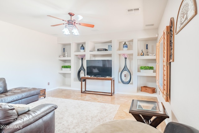 3597 W Mineral Butte Dr, San Tan Valley, AZ 85144 - living area with built in shelves, ceiling fan, and tile patterned flooring
