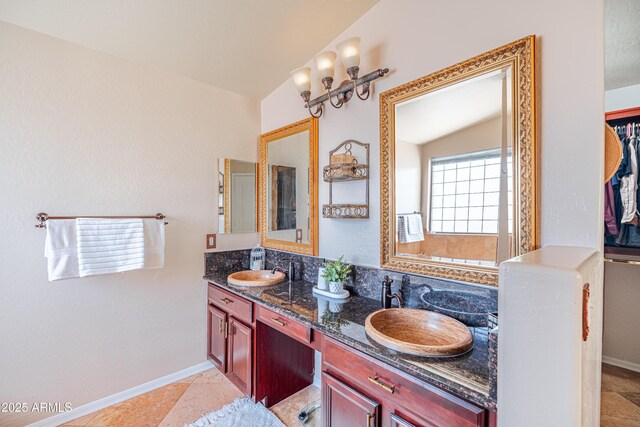 3597 W Mineral Butte Dr, San Tan Valley, AZ 85144 - full bathroom featuring double vanity, vaulted ceiling, and a spacious closet