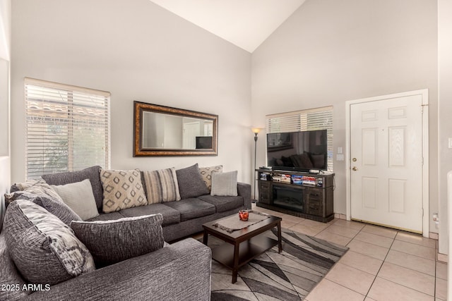 living room with light tile patterned flooring and high vaulted ceiling