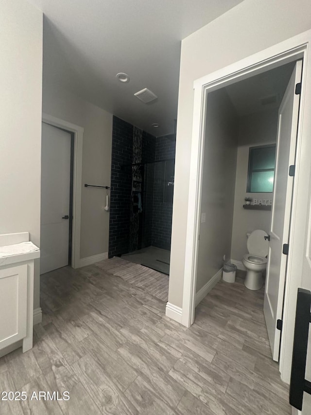 29476 N Wolfe Trl, Florence, AZ 85132 - bathroom with toilet, a shower stall, vanity, and wood finished floors