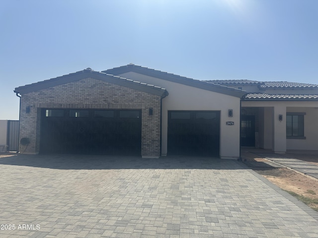 29476 N Wolfe Trl, Florence, AZ 85132 - single story home featuring brick siding, decorative driveway, an attached garage, and a tile roof