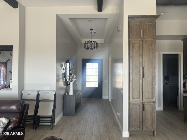 29476 N Wolfe Trl, Florence, AZ 85132 - doorway to outside with light wood finished floors, a tray ceiling, and baseboards