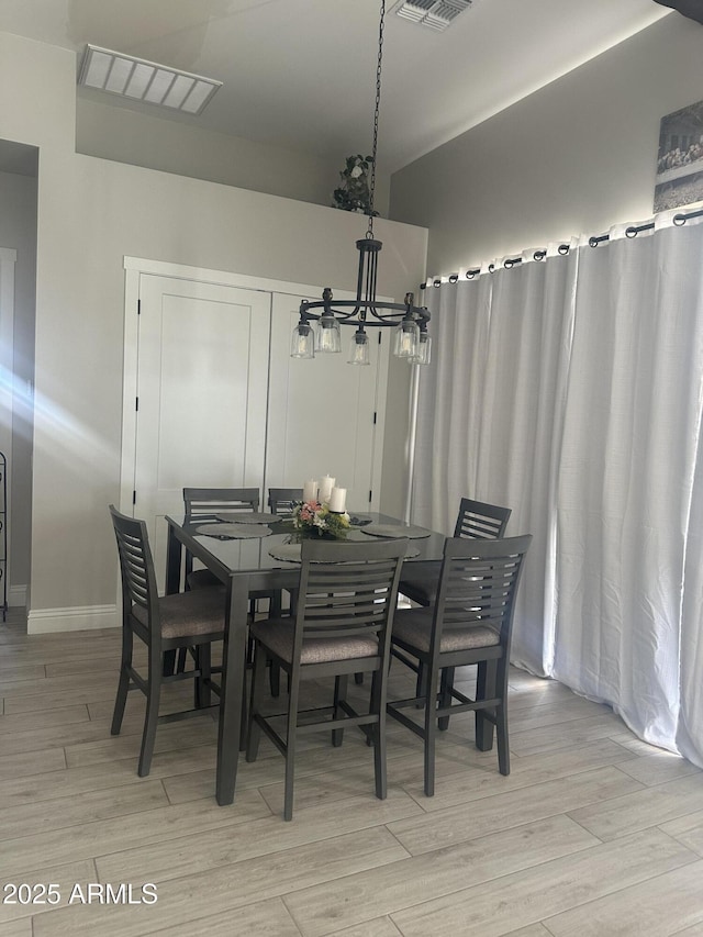 29476 N Wolfe Trl, Florence, AZ 85132 - dining space featuring a chandelier, light wood finished floors, and baseboards