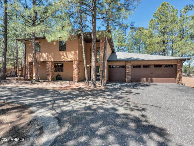 951 N Sky View St, Flagstaff, AZ 86004 - view of front facade featuring driveway, an attached garage, and brick siding