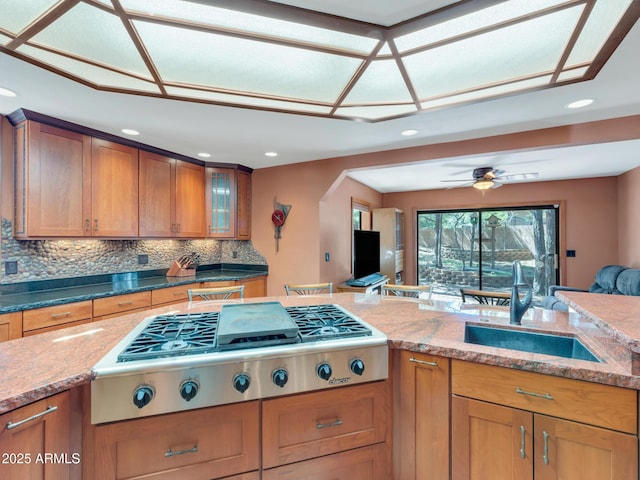 951 N Sky View St, Flagstaff, AZ 86004 - kitchen featuring a sink, stainless steel gas cooktop, brown cabinets, recessed lighting, and light stone countertops