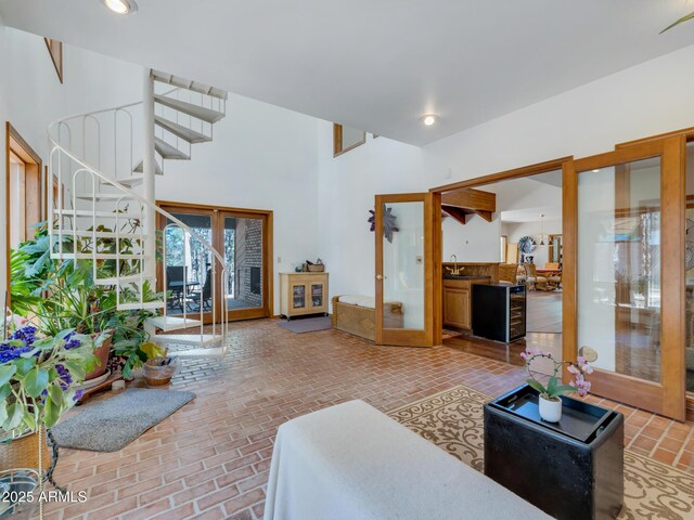 951 N Sky View St, Flagstaff, AZ 86004 - living room featuring french doors, brick flooring, and stairs