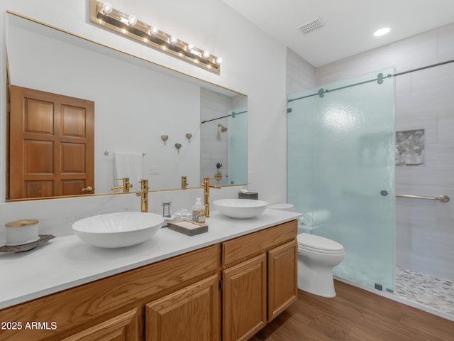 951 N Sky View St, Flagstaff, AZ 86004 - full bathroom featuring a stall shower, wood finished floors, double vanity, and toilet