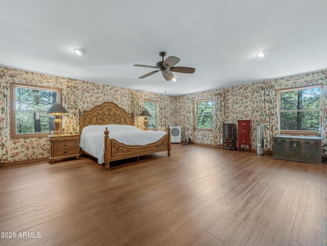 951 N Sky View St, Flagstaff, AZ 86004 - bedroom with wallpapered walls, wood finished floors, baseboards, and a ceiling fan