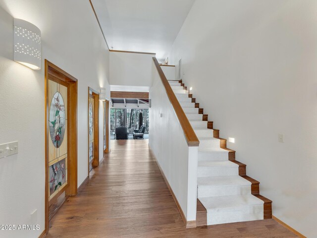 951 N Sky View St, Flagstaff, AZ 86004 - staircase featuring wood finished floors, a towering ceiling, and baseboards