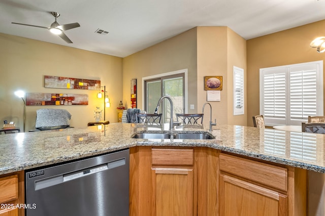 kitchen with light stone counters, ceiling fan, dishwasher, and sink