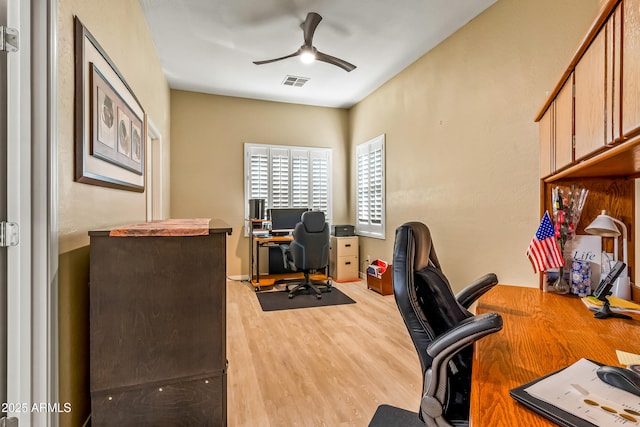 home office with hardwood / wood-style flooring and ceiling fan