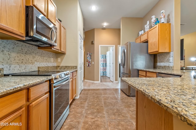 kitchen featuring stainless steel appliances, light tile patterned floors, backsplash, and light stone counters