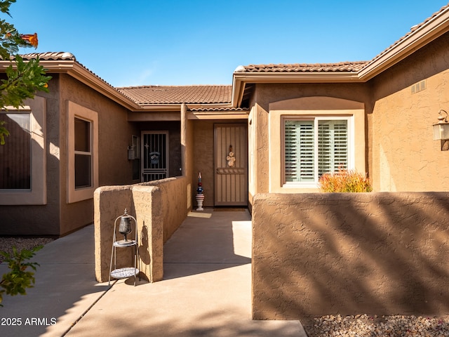 entrance to property with a patio