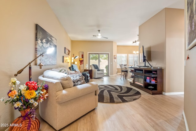 living room with wood-type flooring and ceiling fan