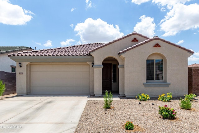 10223 W Piccadilly Rd, Avondale, AZ 85392 - mediterranean / spanish house with a tile roof, concrete driveway, an attached garage, and stucco siding