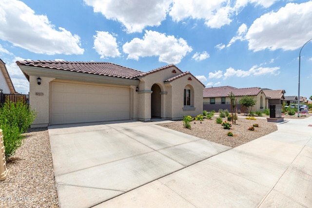 10223 W Piccadilly Rd, Avondale, AZ 85392 - mediterranean / spanish-style home with stucco siding, a tiled roof, driveway, and a garage