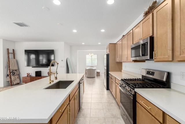 10223 W Piccadilly Rd, Avondale, AZ 85392 - kitchen featuring appliances with stainless steel finishes, a sink, recessed lighting, light countertops, and open floor plan
