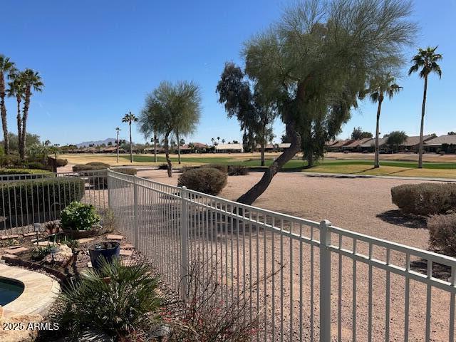 view of home's community featuring fence