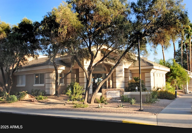 ranch-style home with a tiled roof