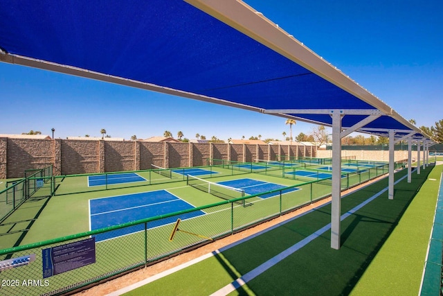 view of tennis court featuring fence