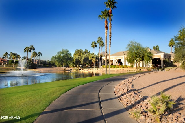 surrounding community featuring a water view and a yard