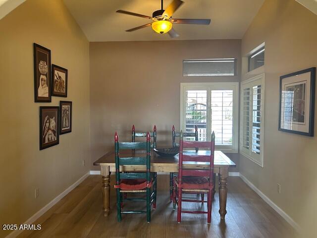 dining area with a ceiling fan, baseboards, and wood finished floors