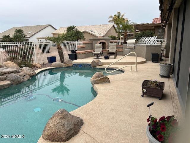 view of swimming pool with a fenced backyard, a patio, a fenced in pool, and area for grilling