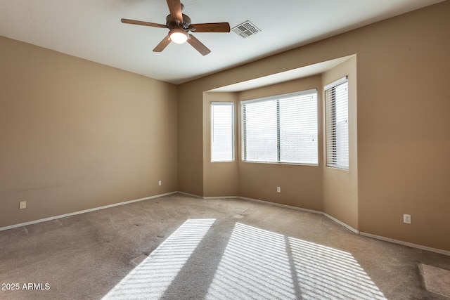 carpeted spare room with ceiling fan