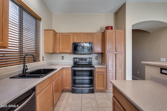 kitchen with dishwashing machine, light tile patterned floors, stainless steel electric stove, and sink