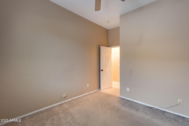 carpeted spare room with ceiling fan