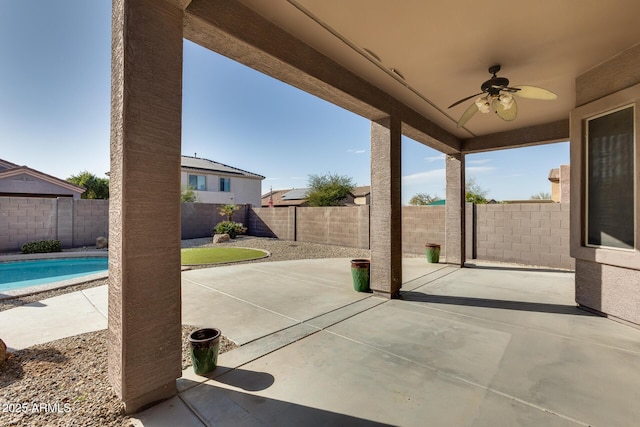 view of patio / terrace with a fenced in pool and ceiling fan