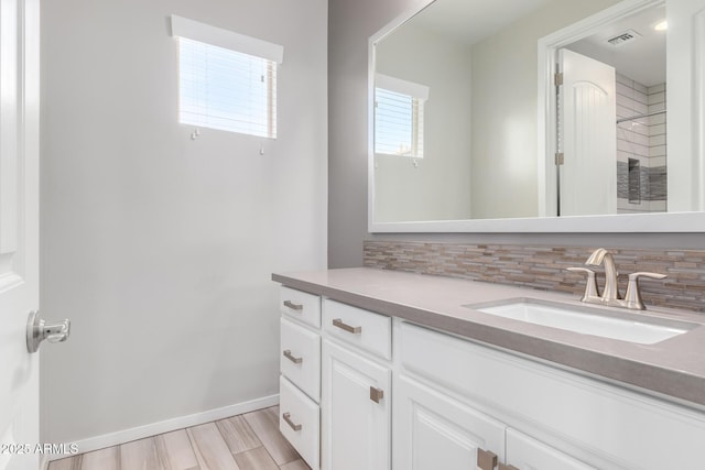 1848 S Follett Way, Gilbert, AZ 85295 - bathroom with decorative backsplash, vanity, baseboards, and wood finished floors