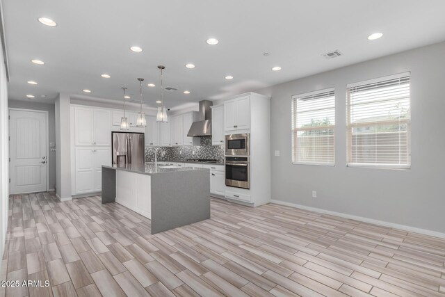 1848 S Follett Way, Gilbert, AZ 85295 - kitchen with stainless steel appliances, wall chimney exhaust hood, baseboards, white cabinets, and recessed lighting