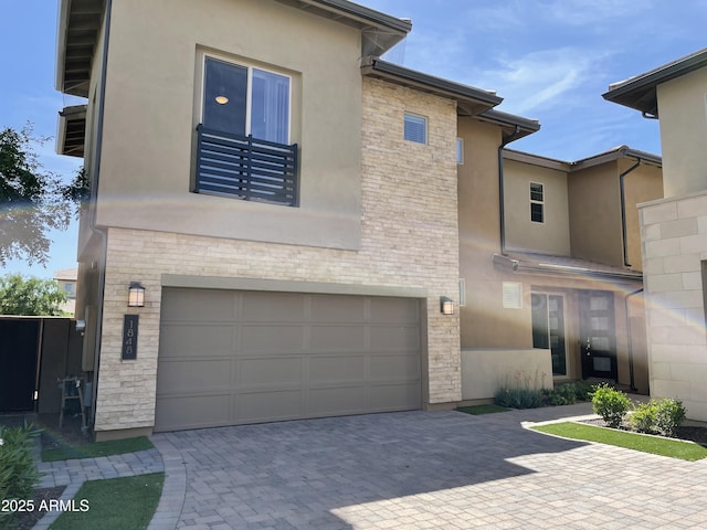 1848 S Follett Way, Gilbert, AZ 85295 - view of front of home with an attached garage, stucco siding, stone siding, and decorative driveway
