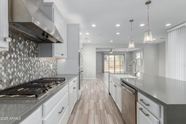 1848 S Follett Way, Gilbert, AZ 85295 - kitchen featuring wall chimney range hood, stainless steel appliances, a sink, recessed lighting, and baseboards