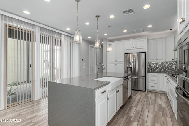 1848 S Follett Way, Gilbert, AZ 85295 - kitchen with appliances with stainless steel finishes, a sink, white cabinets, backsplash, and recessed lighting