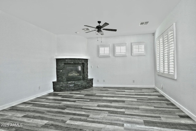 unfurnished living room featuring hardwood / wood-style floors, a fireplace, and ceiling fan