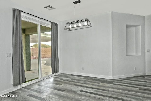 unfurnished dining area featuring dark wood-type flooring