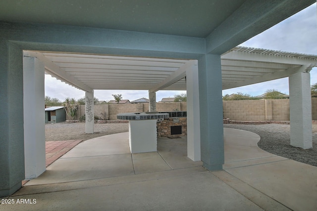 view of patio / terrace with exterior kitchen and a pergola