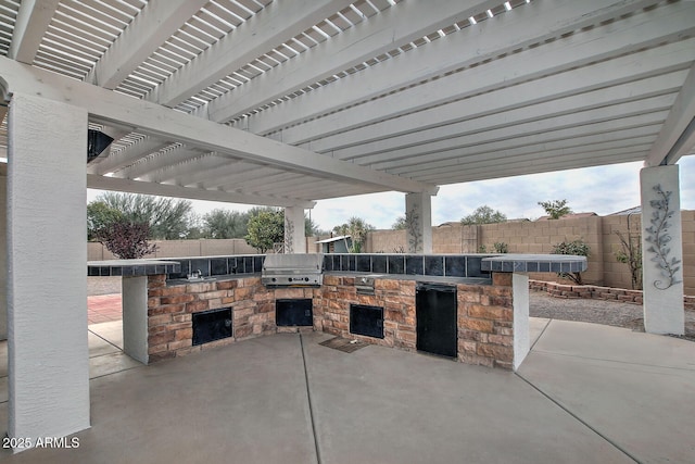 view of patio / terrace featuring area for grilling and a pergola