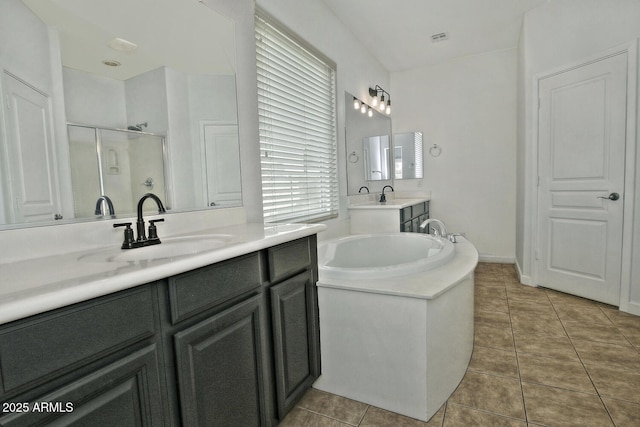 bathroom featuring vanity, tile patterned flooring, and plus walk in shower