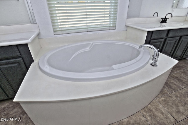 bathroom featuring vanity, tile patterned floors, and a tub