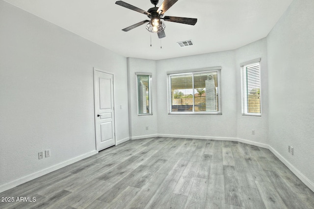 spare room with light hardwood / wood-style floors and ceiling fan