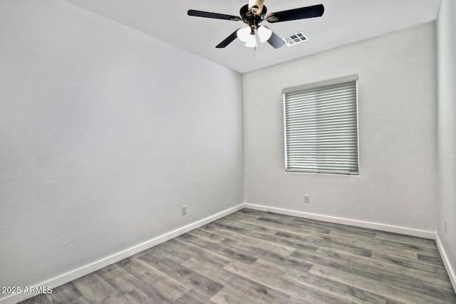 spare room featuring ceiling fan and hardwood / wood-style floors