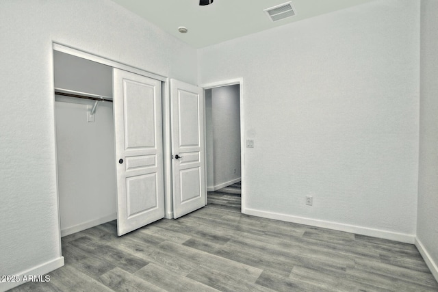 unfurnished bedroom with a closet and light hardwood / wood-style floors