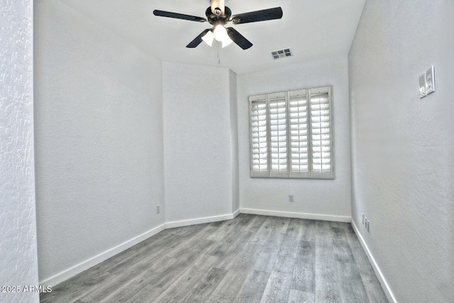 spare room with light wood-type flooring and ceiling fan