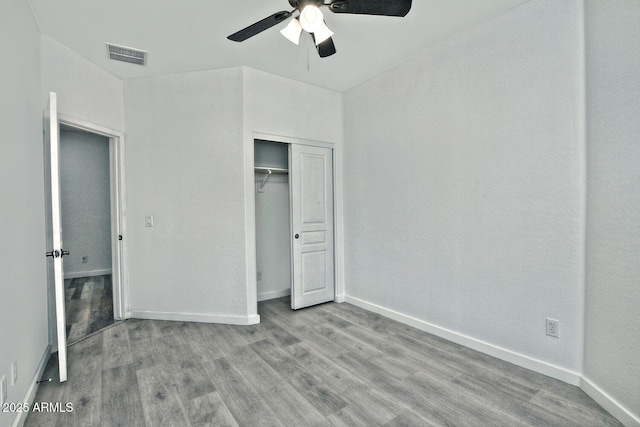 unfurnished bedroom with a closet, ceiling fan, and light hardwood / wood-style floors